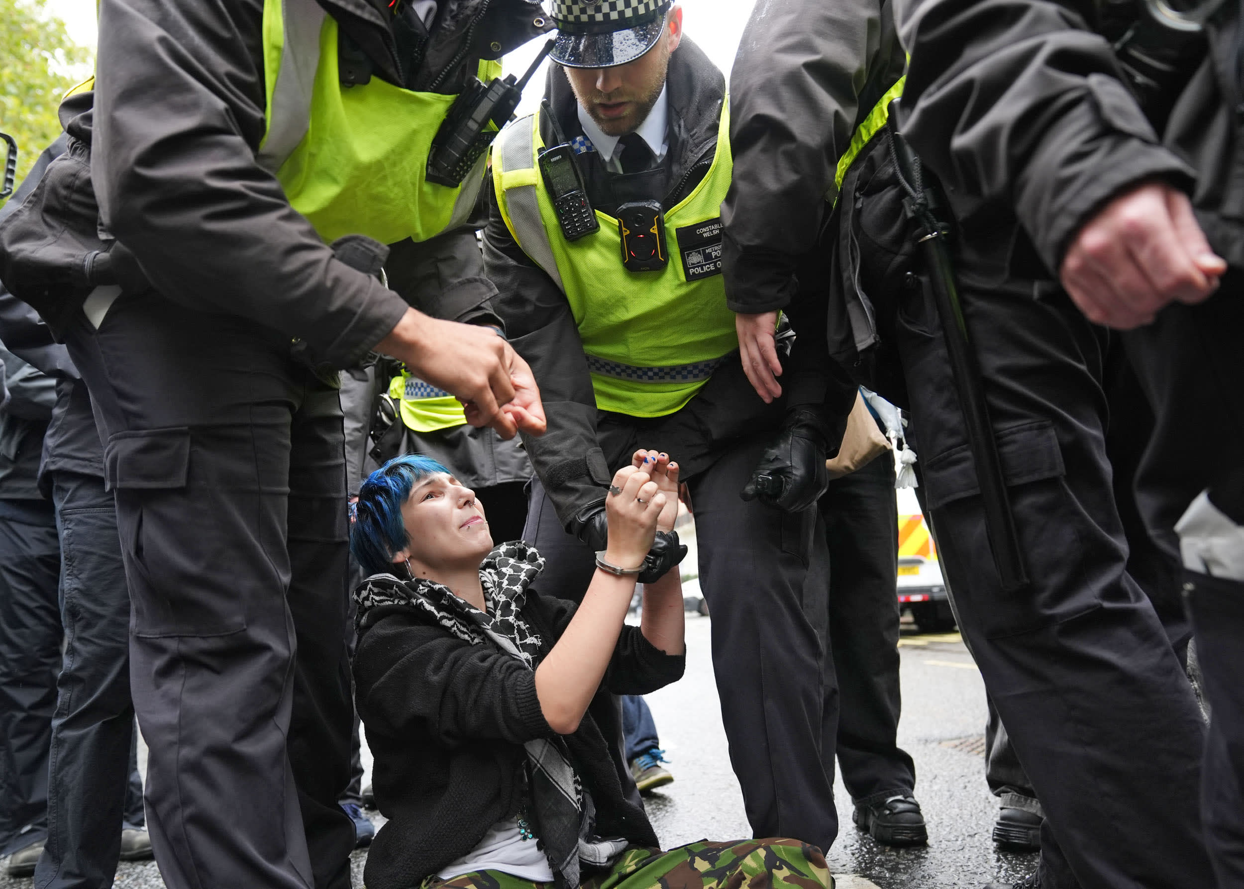 Police remove a demonstrator during a student march in support of Palestinians in London on Oct. 7, 2026.