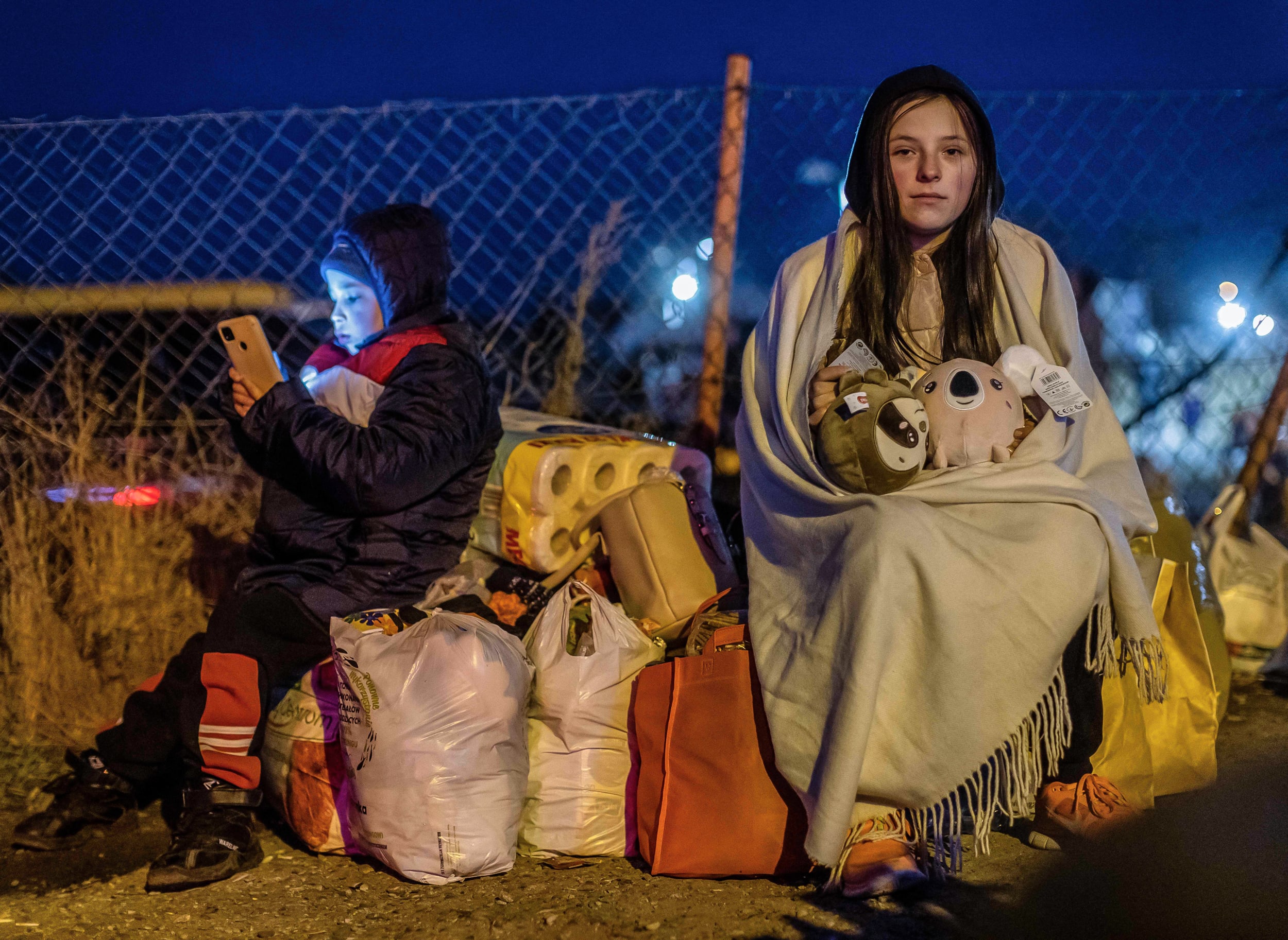 Image: Helena, right, and her brother Bodia from Lviv, at the Medyka pedestrian border crossing, in eastern Poland on Feb. 26, 2022.