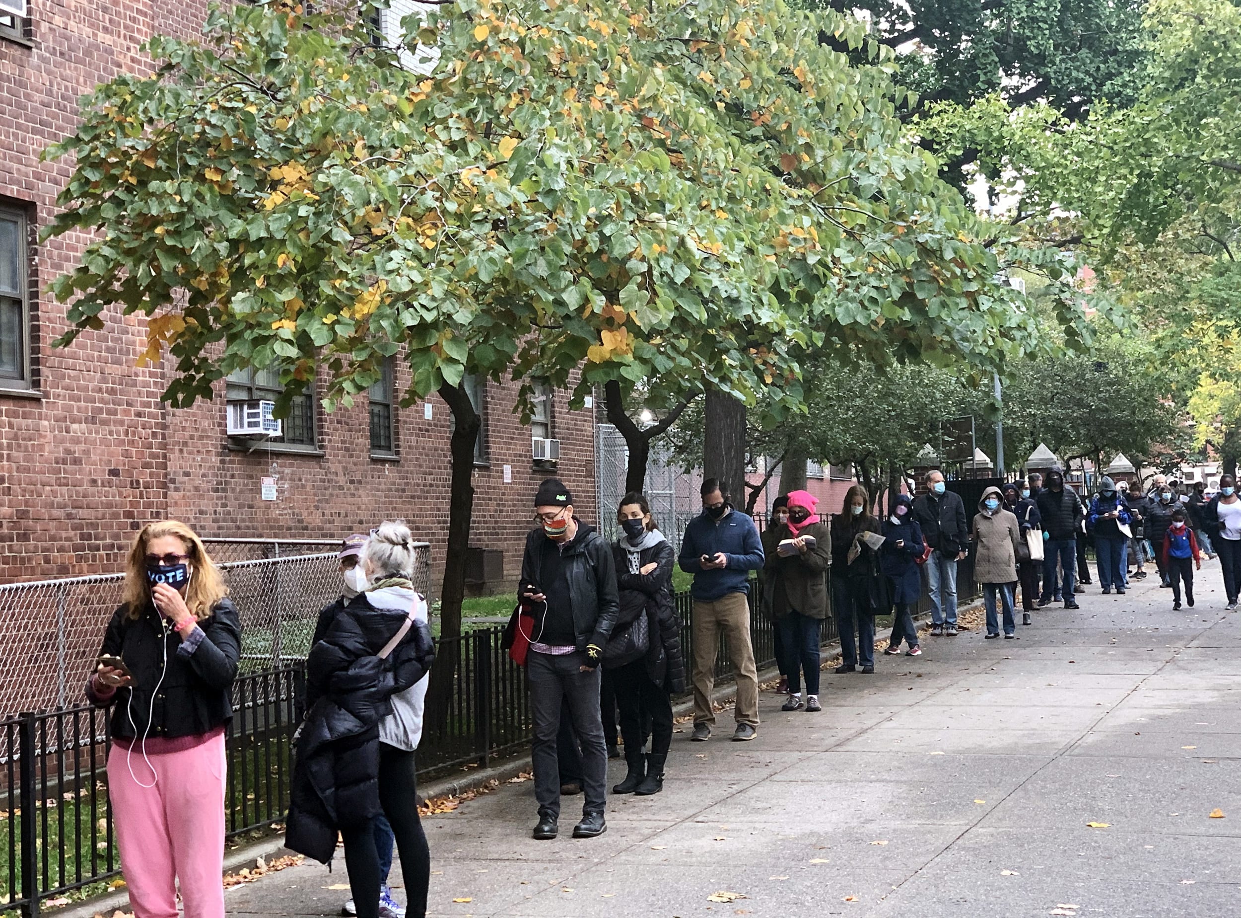 Voters wait in line to cast their ballot on day three of early voting in New York City on Oct. 26, 2020.
