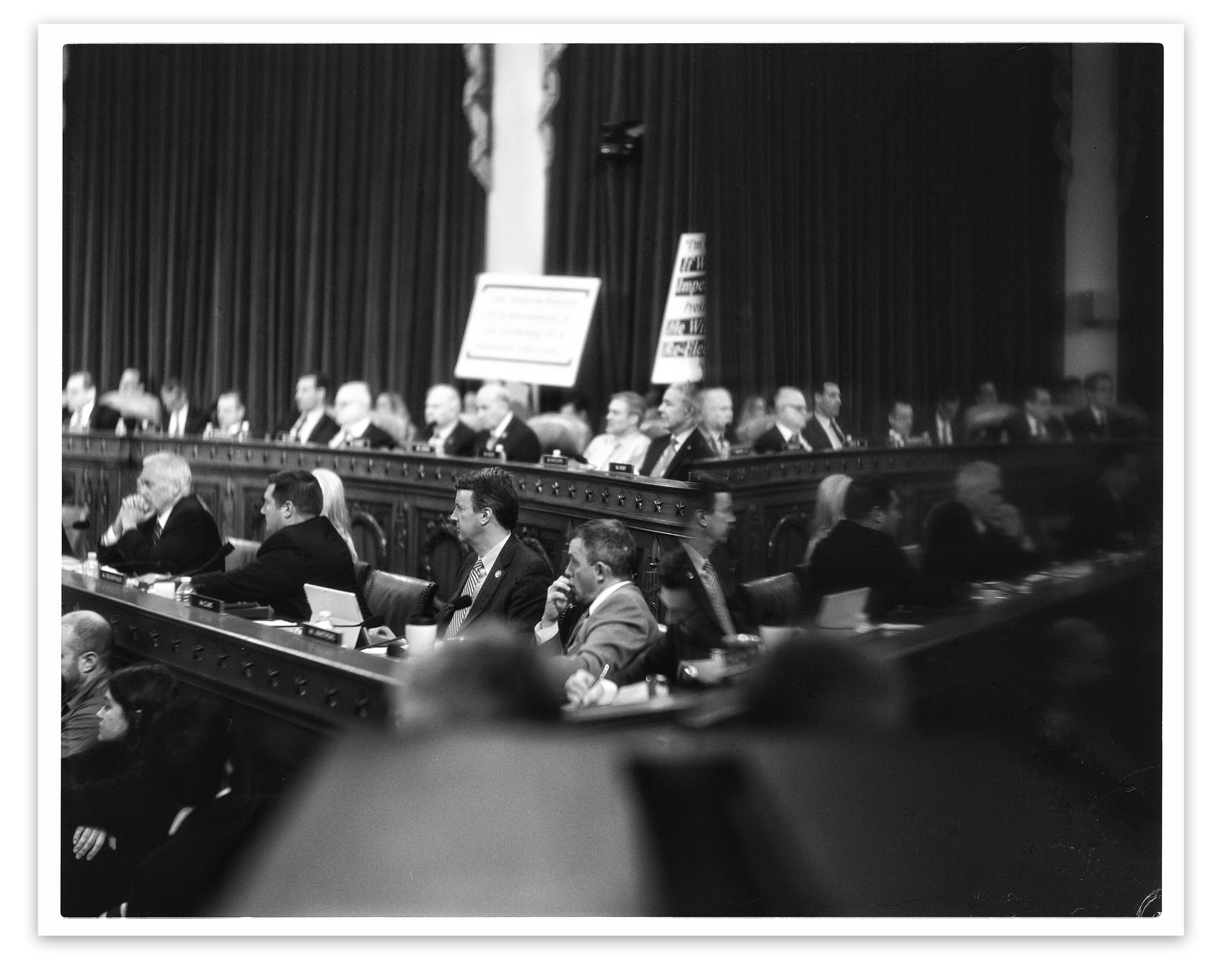 Republican members of the House Judiciary Committee are reflected off a television monitor during the committee markup of the articles of impeachment, a process which lasted three days, on Dec. 12.