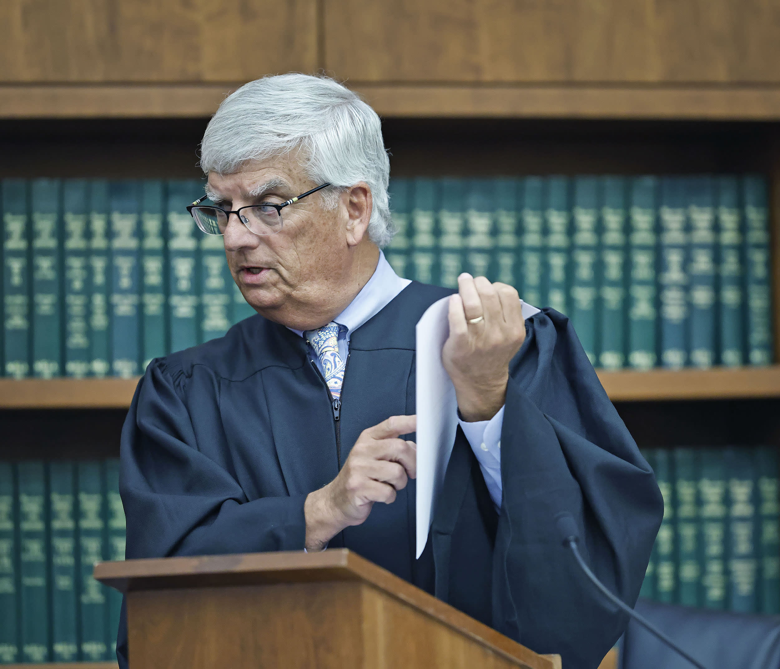 Judge William Sullivan holds up the jury slip for the jury as he gives his final instructions.