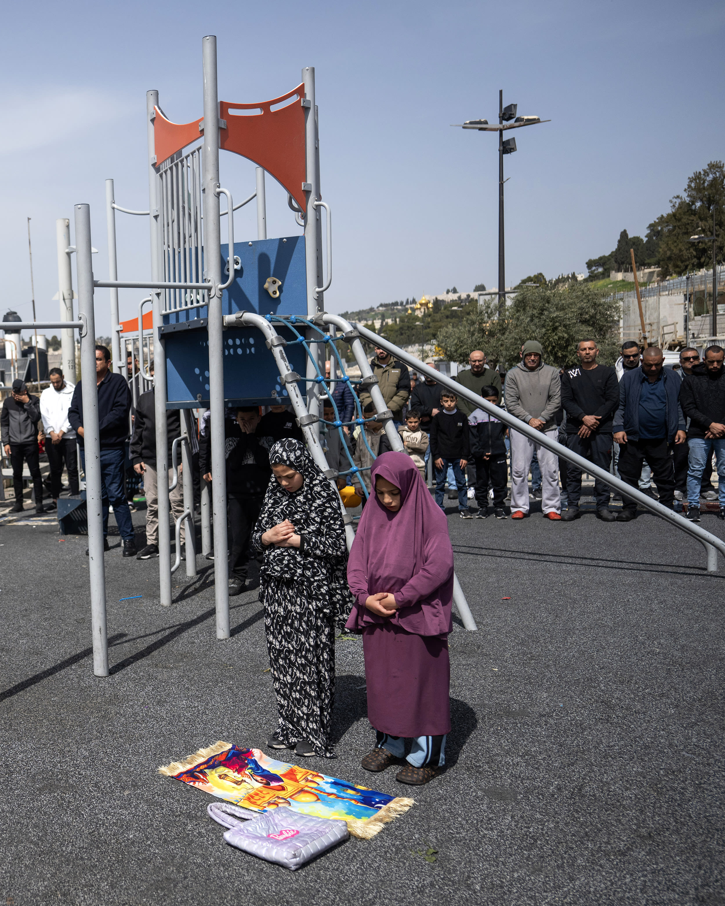 Palestinians perform Friday prayers in the streets after Israel closed Al-Aqsa Mosque to worship
