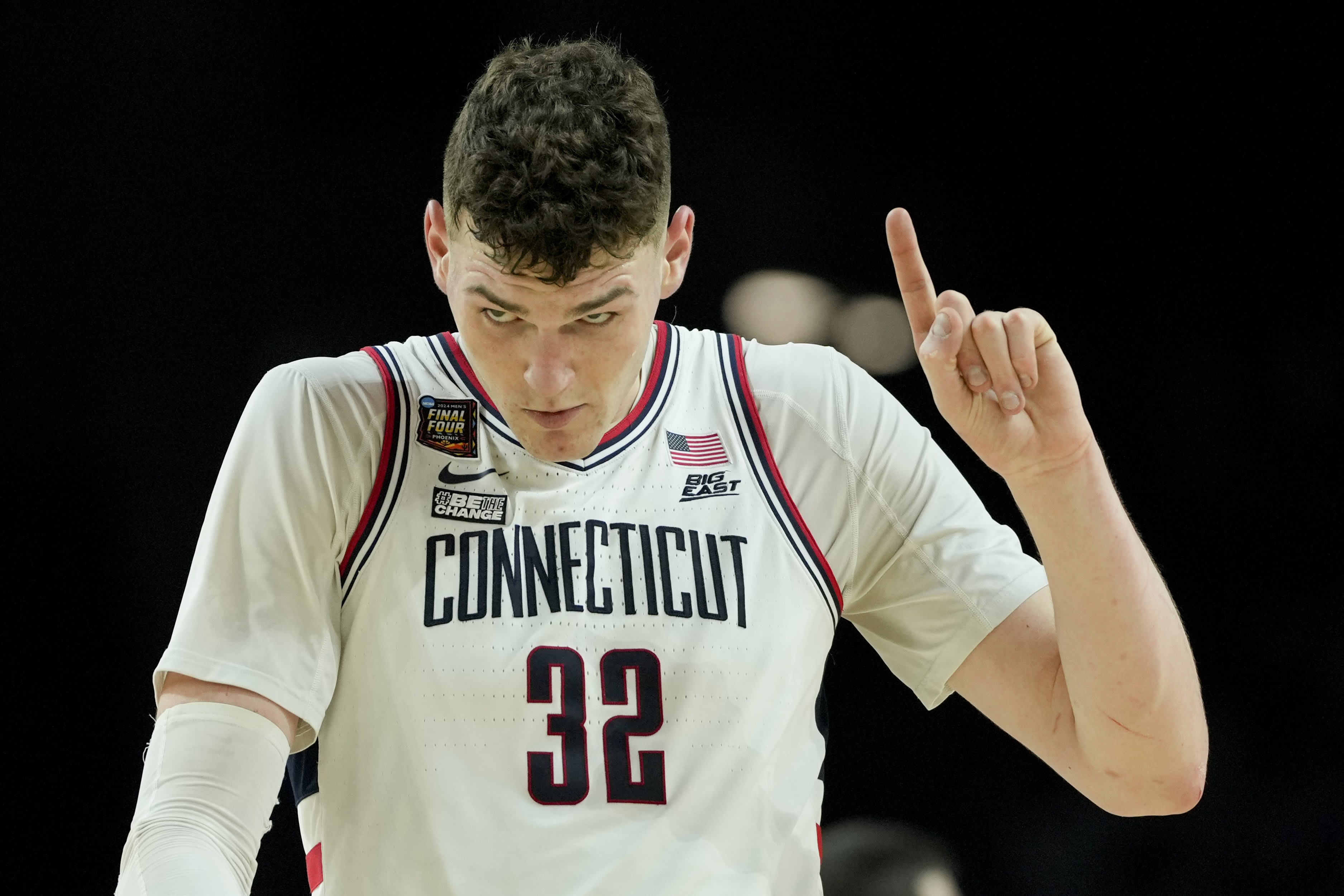 UConn center Donovan Clingan (32) celebrates after their win against Alabama in a NCAA college basketball game at the Final Four, Saturday, April 6, 2024, in Glendale, Ariz. 