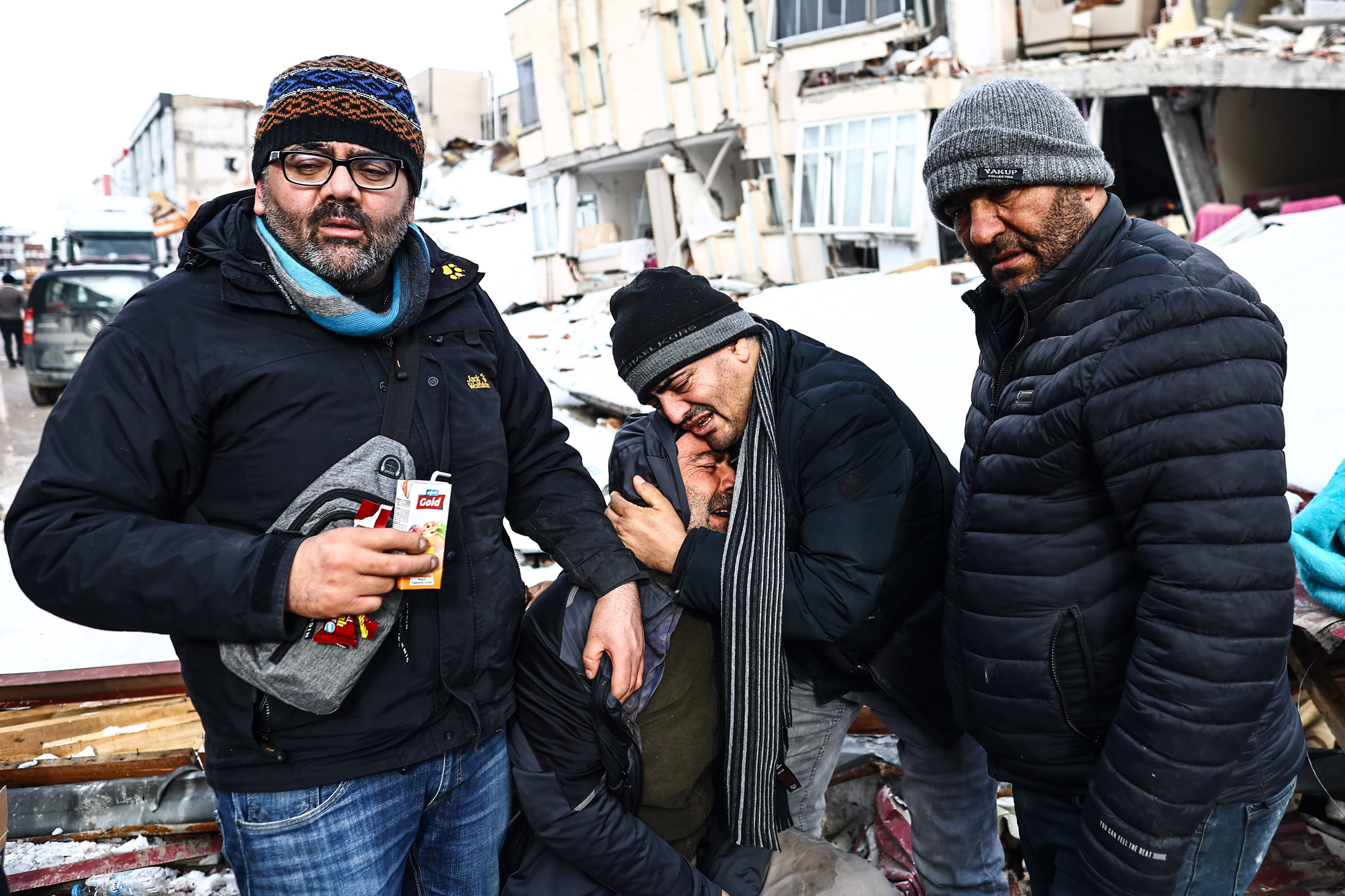 Image: People affected by a major earthquake react at the site of collapsed buildings in Elbistan district of Kahramanmaras