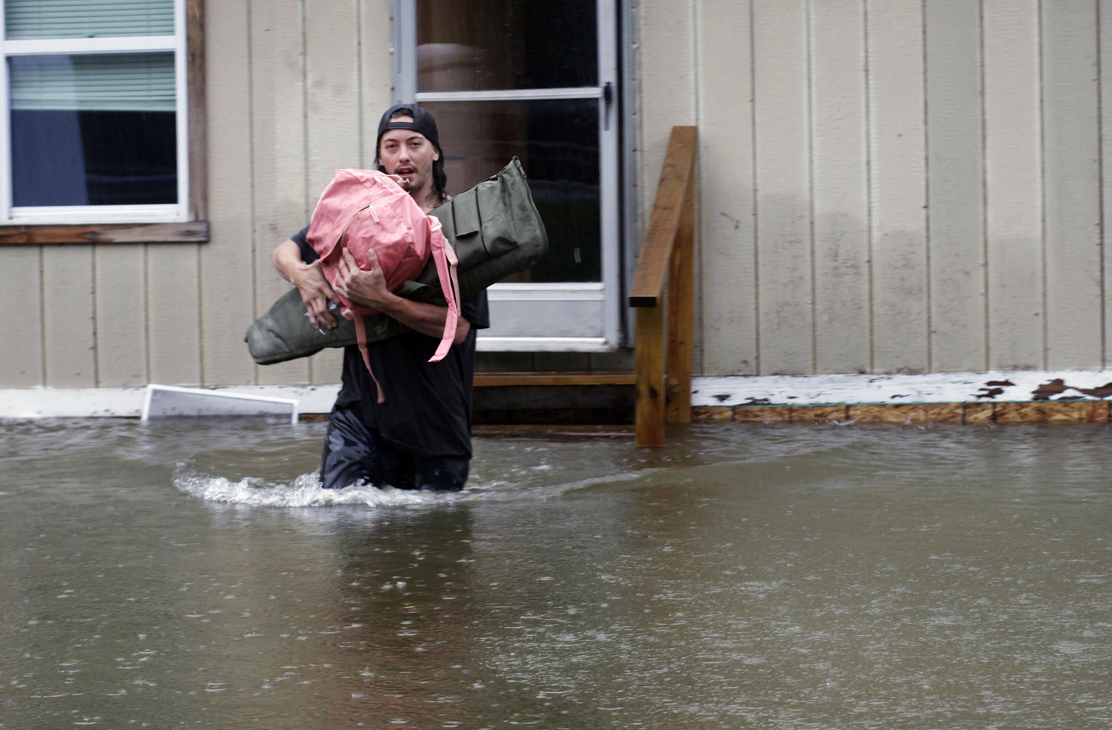 Heavy rain drenched part of the Northeast, washing out roads, forcing evacuations and halting some airline travel. (AP Photo/Hasan Jamali)