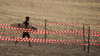 Surfers make for the waves as Australia's Bondi Beach reopens after lockdown