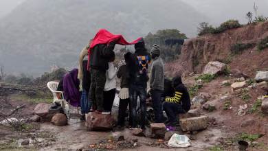 Migrants kept in a Greek field for COVID-19 quarantine