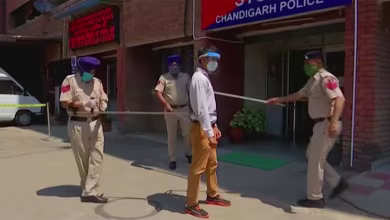 Indian police use five-foot pole to social distance while capturing lockdown offenders