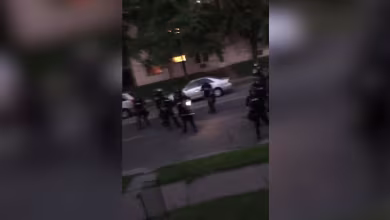 Watch: Law enforcement appears to shoot paint canisters at residents on front porch