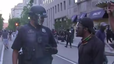 Protesters in D.C. line up to speak with police officer