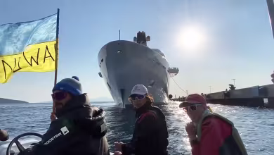 ‘Go away Russian ship, go away!’: Ukrainian activists in small boat face down oligarch’s superyacht