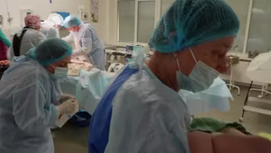 Mariupol hospital worker shields newborn after birth as shelling is heard outside