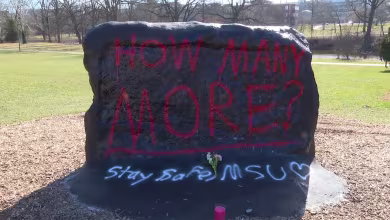 MSU students lay flowers at memorial for shooting victims