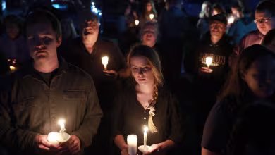 Mourners hold vigil for the 18 victims of Maine mass shooting