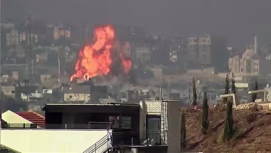 Videos show a huge explosion in Gaza and streaks of rockets launched towards Israel