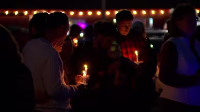 Lewiston residents honor victims of mass shooting during vigil