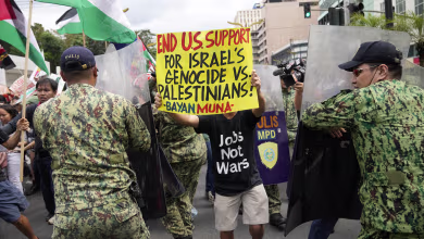 Pro-Palestinian protesters clash with police in front of the U.S. Embassy in Manila