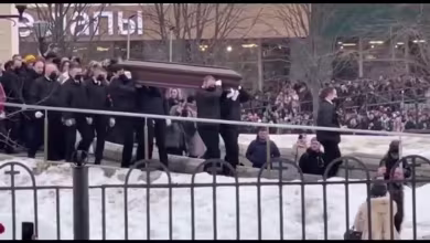 Crowd chants his name as Alexei Navalny's coffin is carried from church