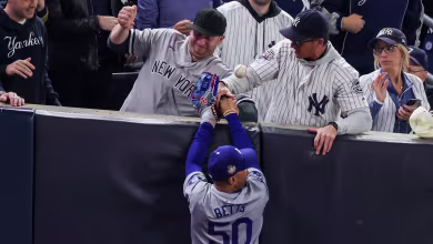 Yankee fans interfere with a foul ball caught by Mookie Betts