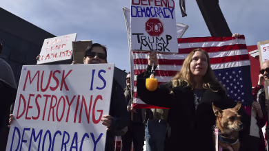 Protesters against Elon Musk gather outside London Tesla dealership