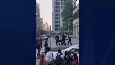NYPD officers carry injured person out of Park Avenue building