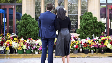 Vances lay flowers at Annunciation Catholic Church memorial