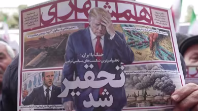 Iranians attend a mass funeral for officials killed in the war