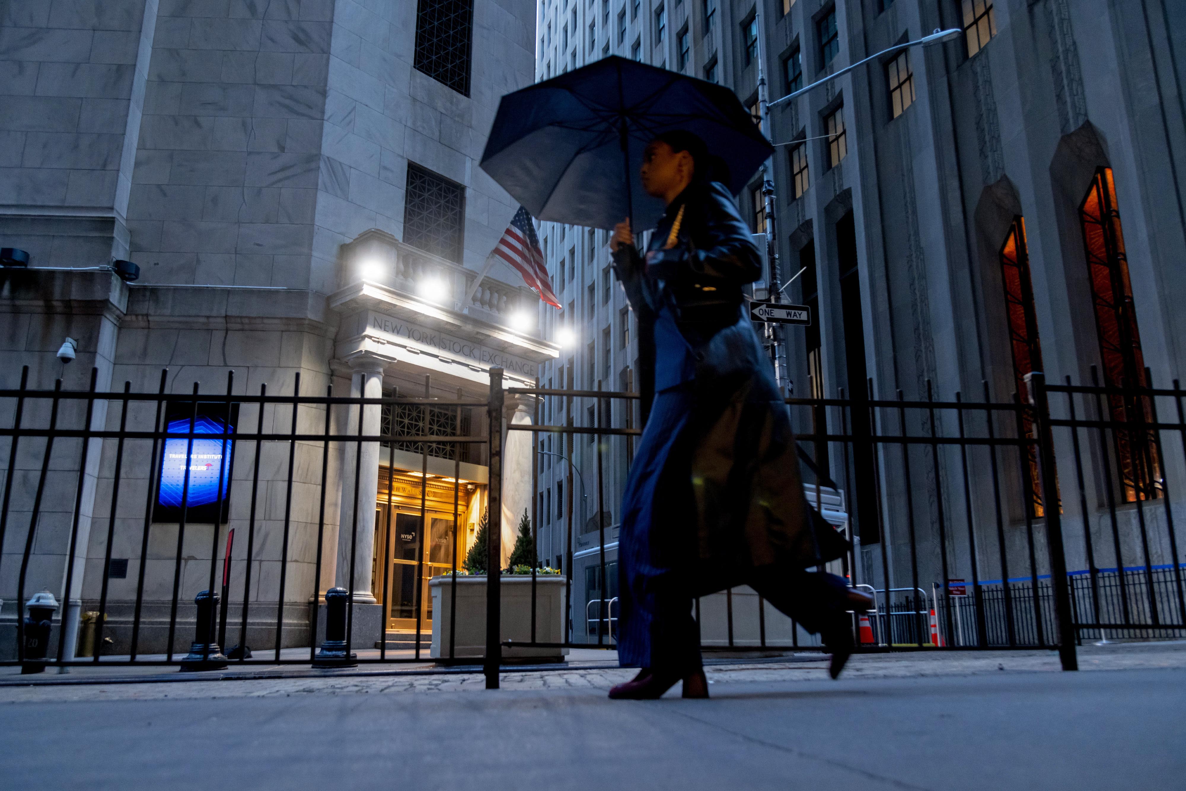 A pedestrian passes the New York Stock Exchange on Monday morning, April 7, 2025.