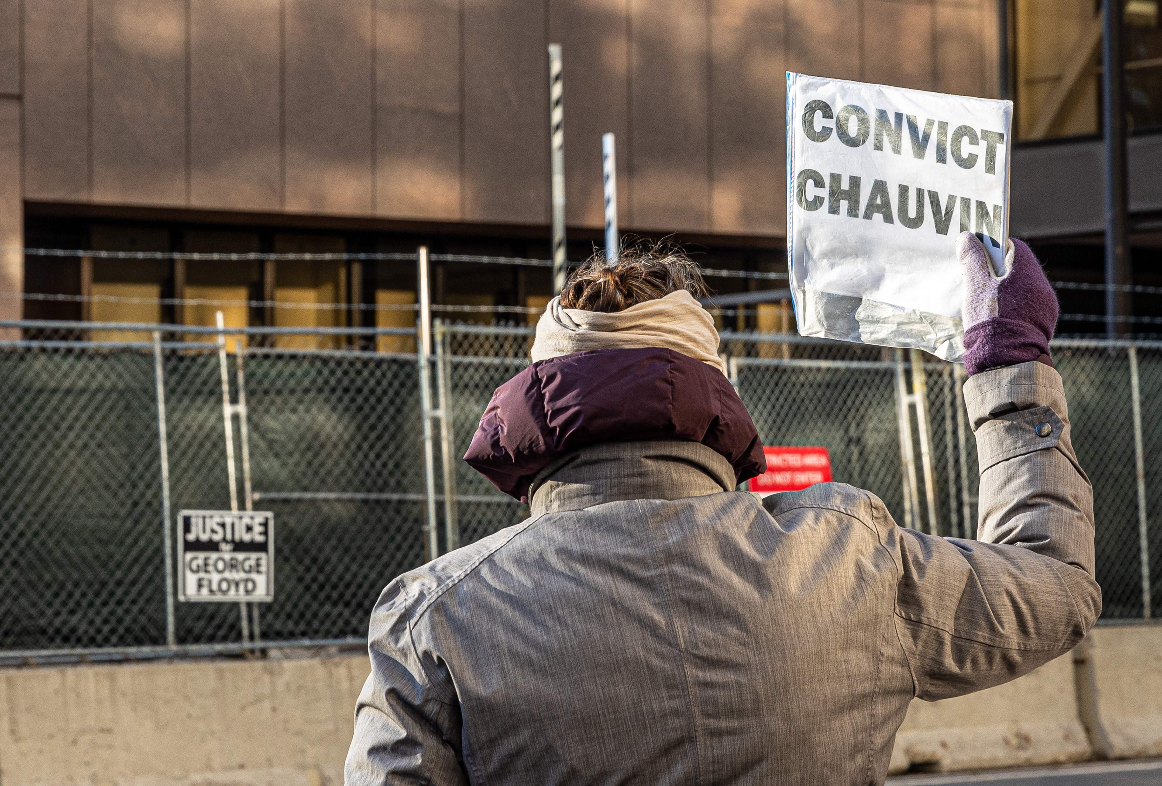 A woman protests outside the Hennepin County Government Center, where the trial of former police officer Derek Chauvin is being held, on March 31, 2021 in Minneapolis, Minn.A woman protests outside the Hennepin County Government Center, where the trial of