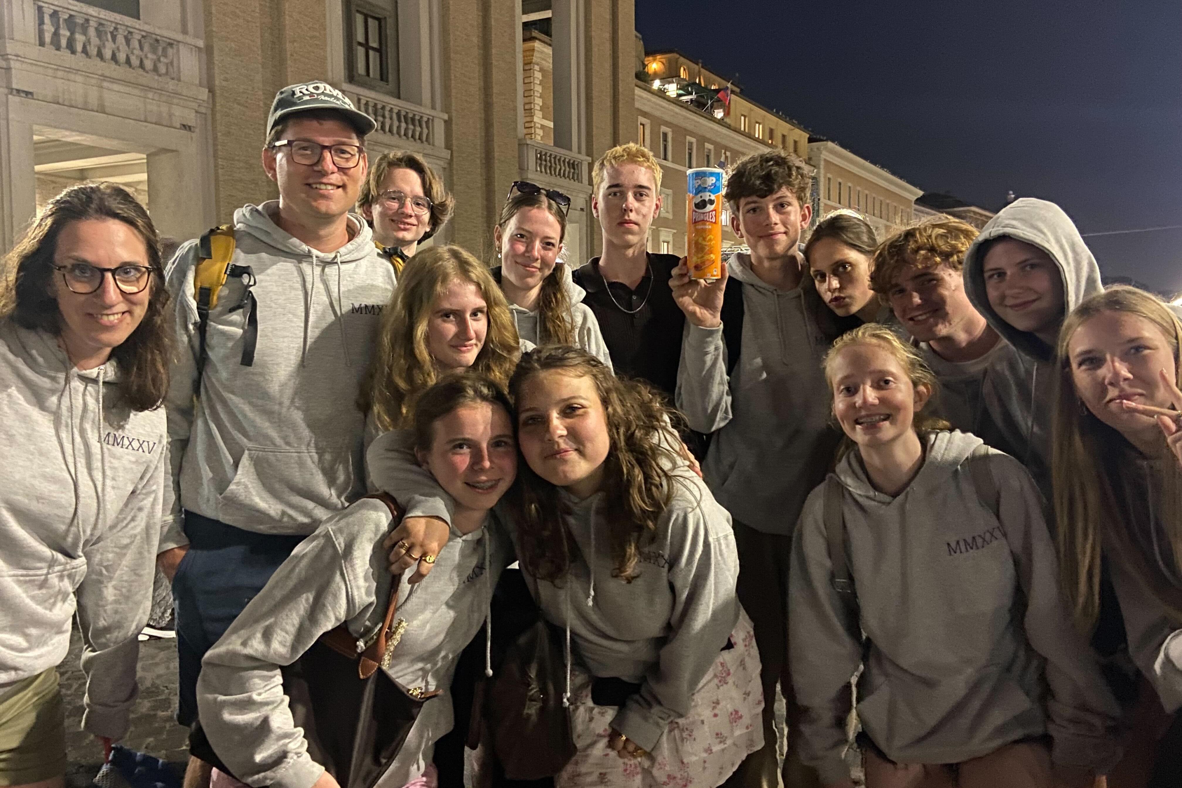 Students on a class trip from the Netherlands, including Shirley, crouching at center.