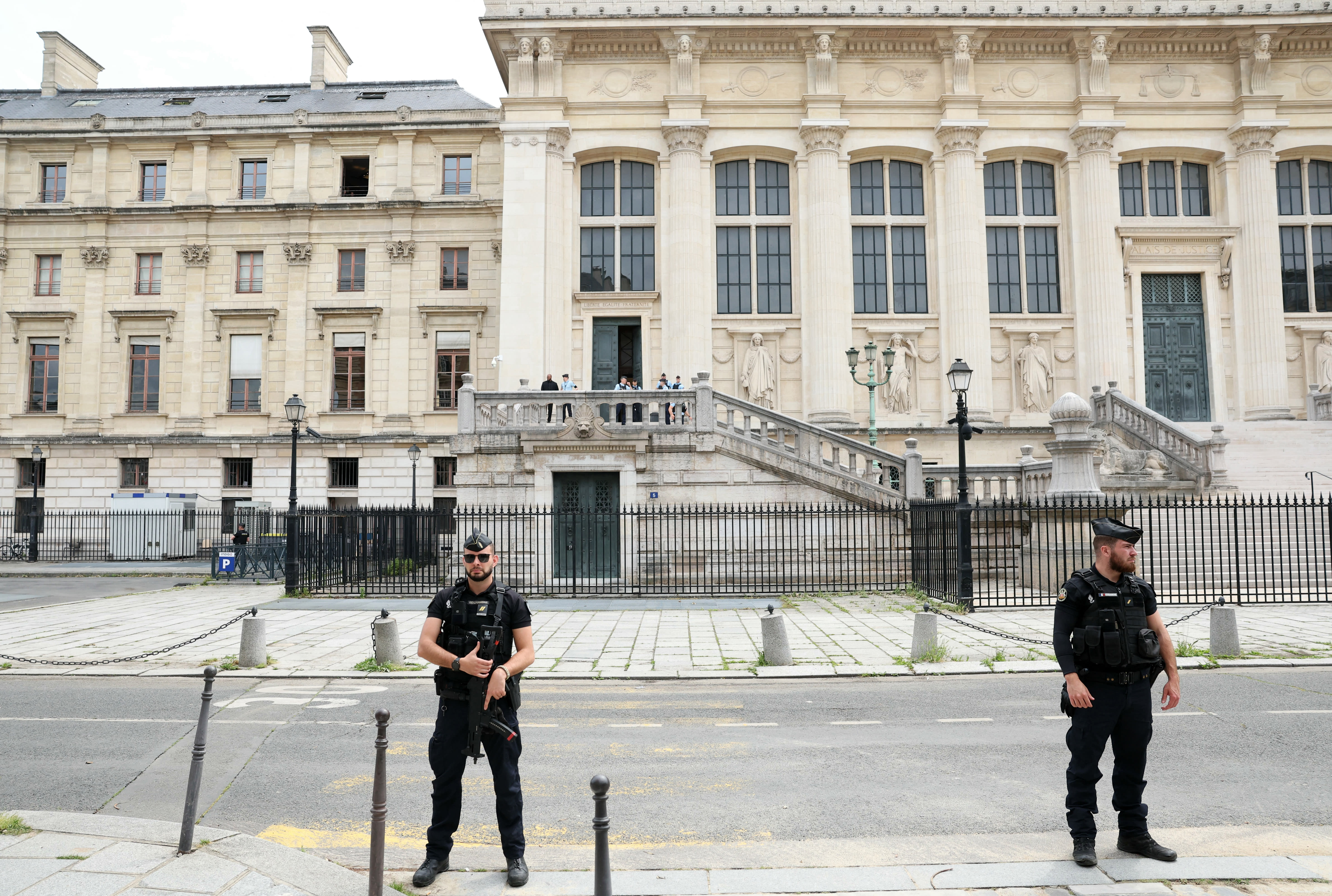 Security forces stand guard near an entrance of the Assize Court