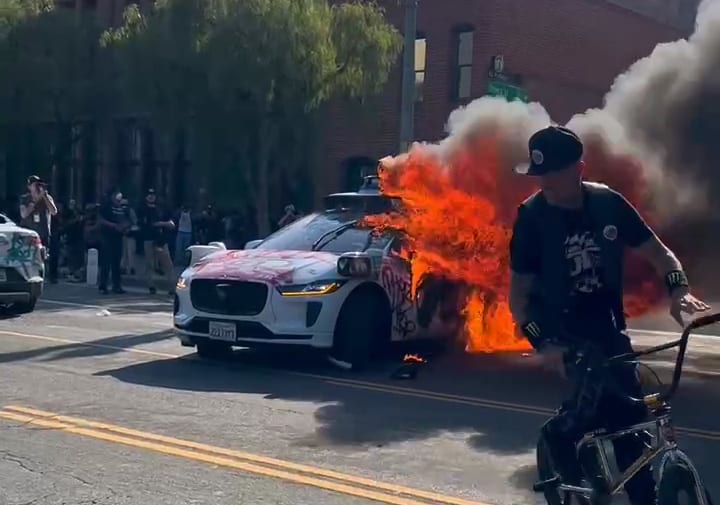 A Waymo autonomous ride-hailing car burns in Los Angeles, Sunday.
