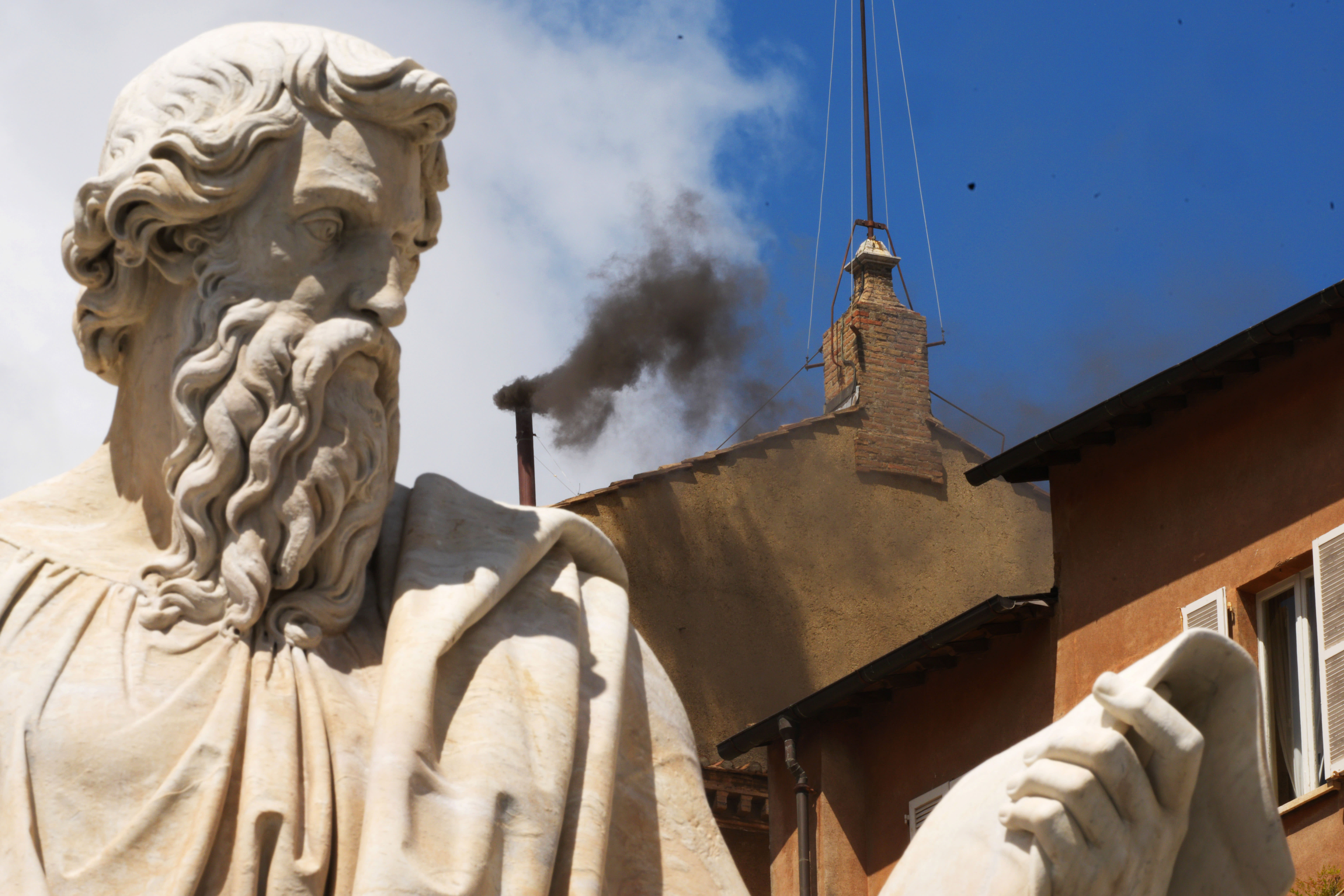 Black smoke is seen from the chimney of the Sistine Chapel as Catholic cardinals gather for a second day to elect a new pope on May 8, 2025 in Vatican City, Vatican.