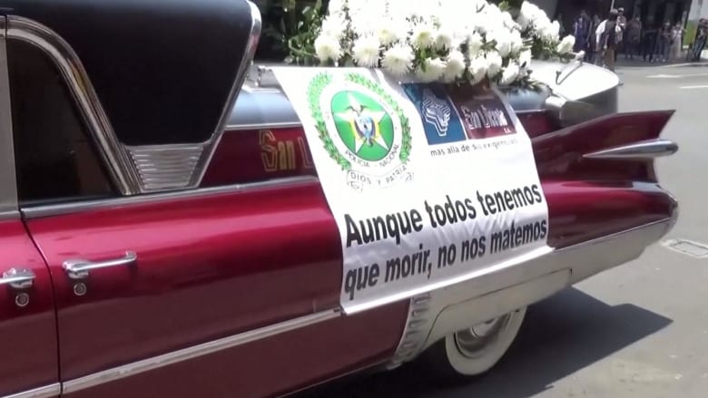 Hearses, songs and drones: How Colombian police get the coronavirus message across