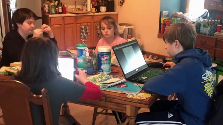 Americans staying at home struggle to balance work and family