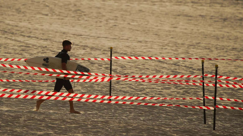 Surfers make for the waves as Australia's Bondi Beach reopens after lockdown
