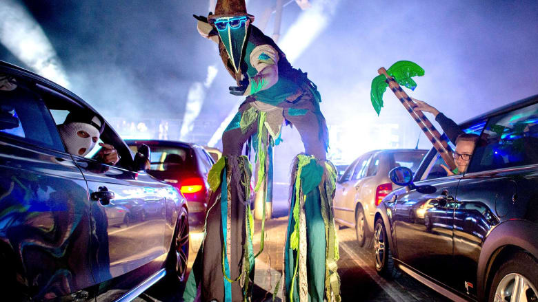 Young Germans rave in their cars at socially-distanced drive-in club night