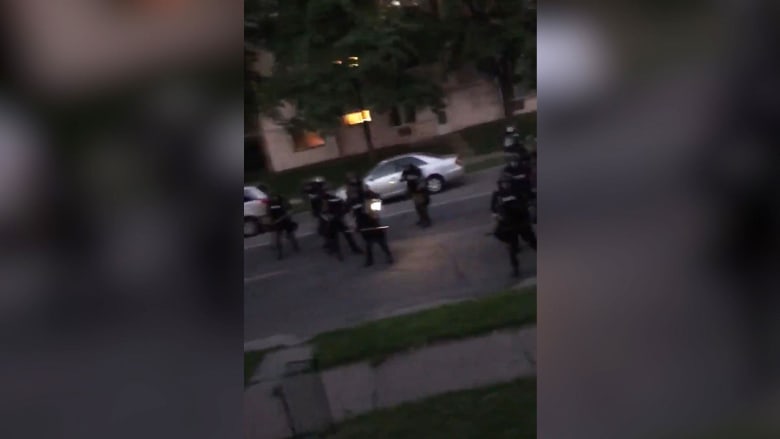 Watch: Law enforcement appears to shoot paint canisters at residents on front porch
