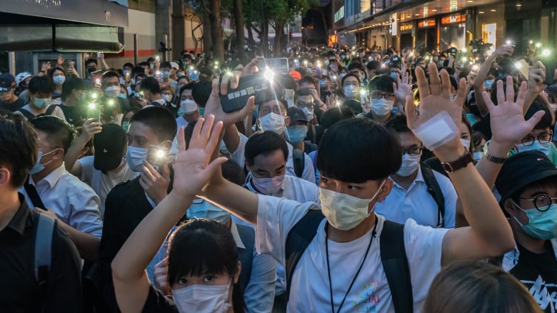 Hundreds defy ban on large gatherings to mark anniversary of Hong Kong pro-democracy protests