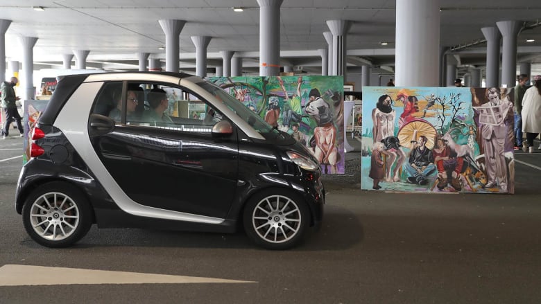 Drive-thru art gallery opens in airport parking garage