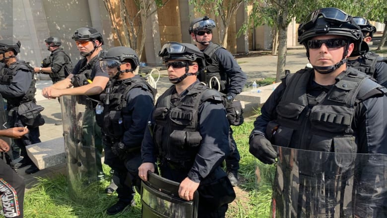 Armed troops remain at DC protest after more charges in Floyd's death