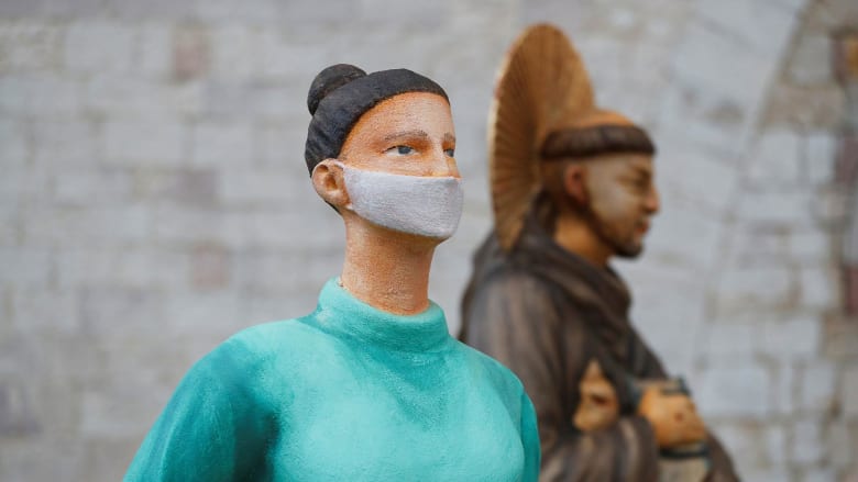 Covid health workers honored at life-size nativity in Assisi, Italy