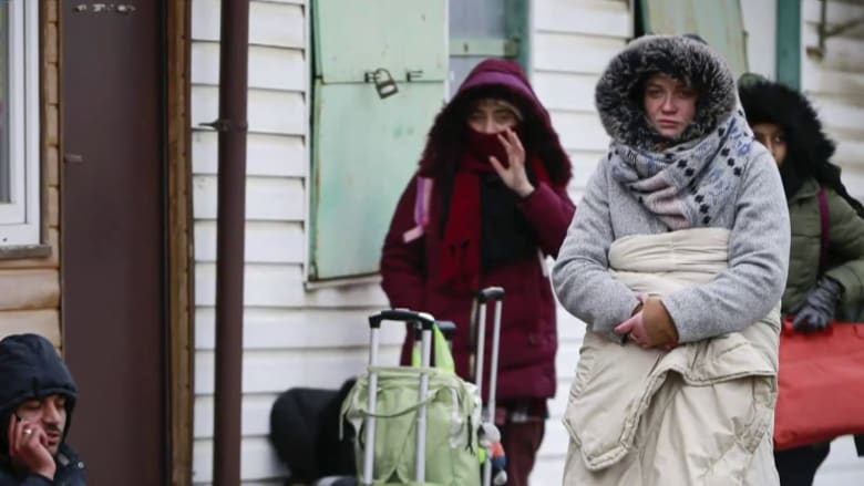Hundreds of thousands of Ukrainians flee as others stay behind