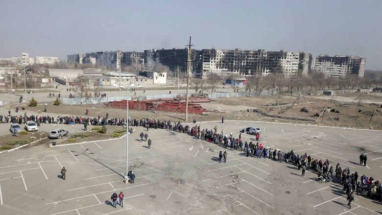 Drone video shows long lines waiting for aid handouts in Mariupol