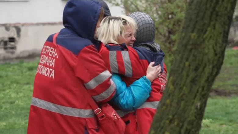 Ukrainian woman mourns as her father lies dead on Kharkiv street after Russian shelling