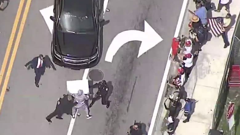 Protester runs up to Trump's motorcade leaving Miami court