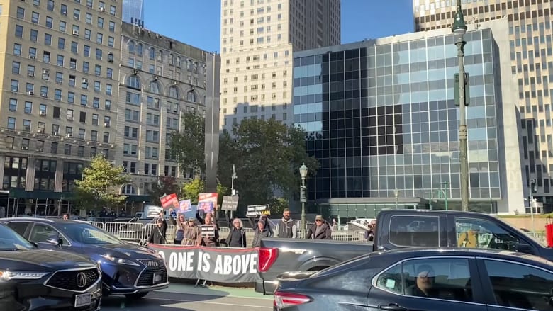Protesters chant 'Trump lies all the time' outside court