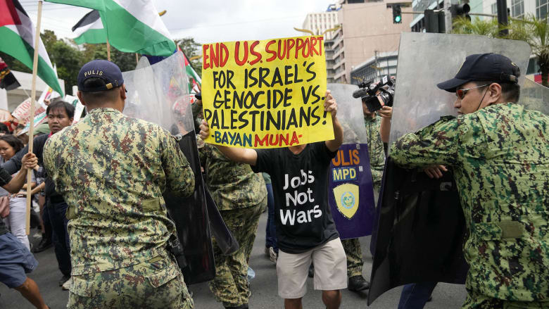 Pro-Palestinian protesters clash with police in front of the U.S. Embassy in Manila