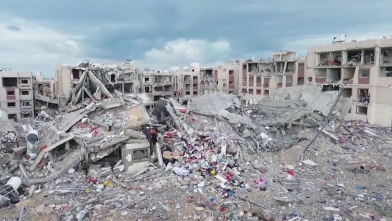 People in Gaza gather belongings amid destruction