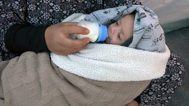 Palestinian baby Anas gets sunshine therapy at camp in Rafah, Gaza